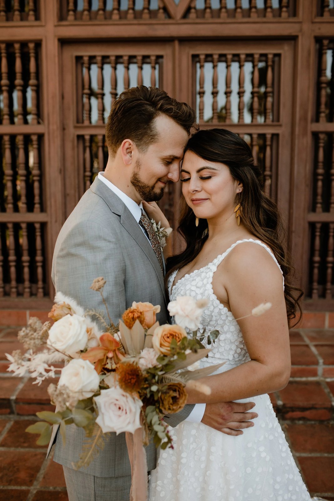 Couple embracing with a warm autumn bouquet